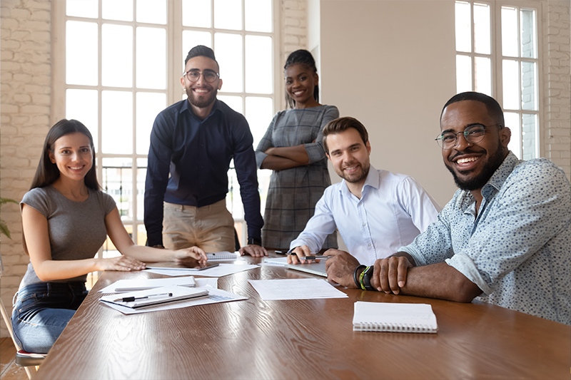 Diverse group of team members sitting in a corporate meeting room