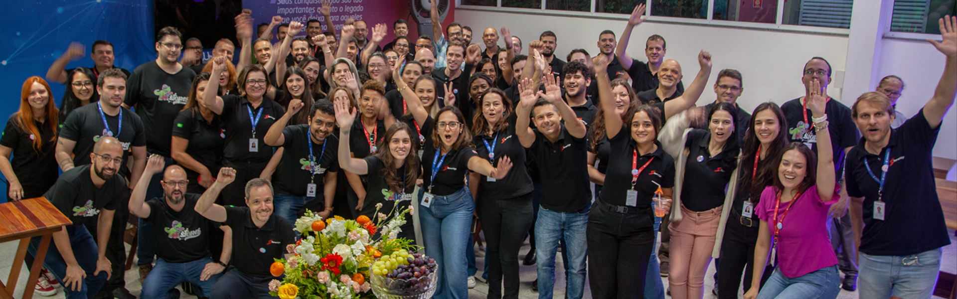 Group of happy employees with hands in the air