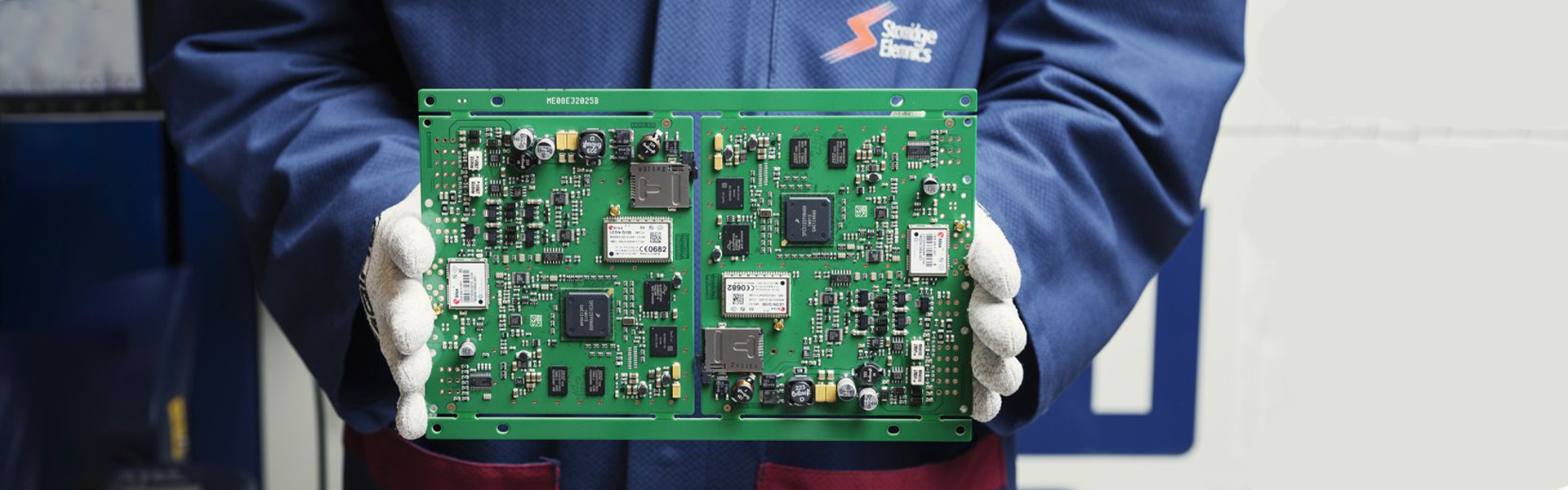 Employee in white gloves holding a circuit board